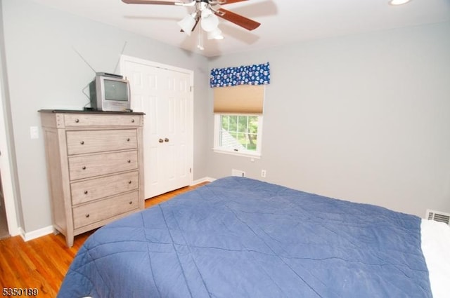 bedroom with baseboards, visible vents, and light wood-type flooring