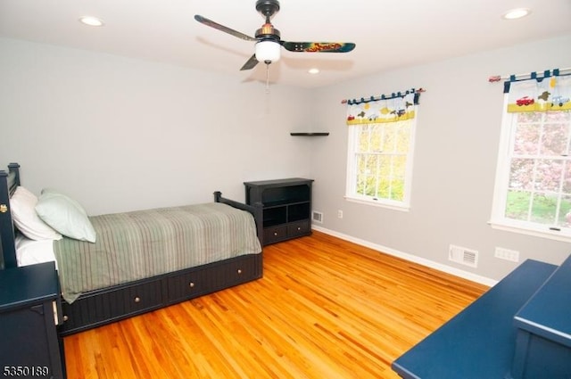 bedroom with recessed lighting, baseboards, visible vents, and wood finished floors