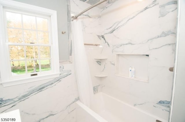 bathroom featuring shower / bath combo with shower curtain