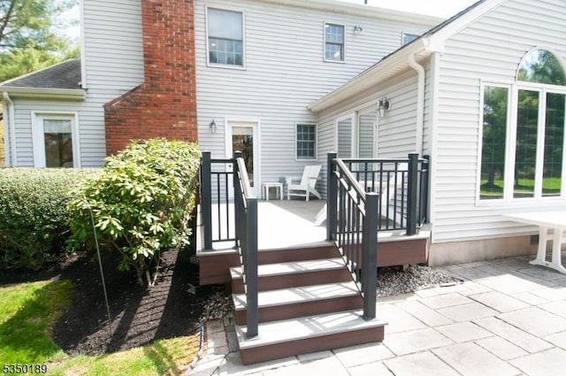 back of property with a patio and a chimney