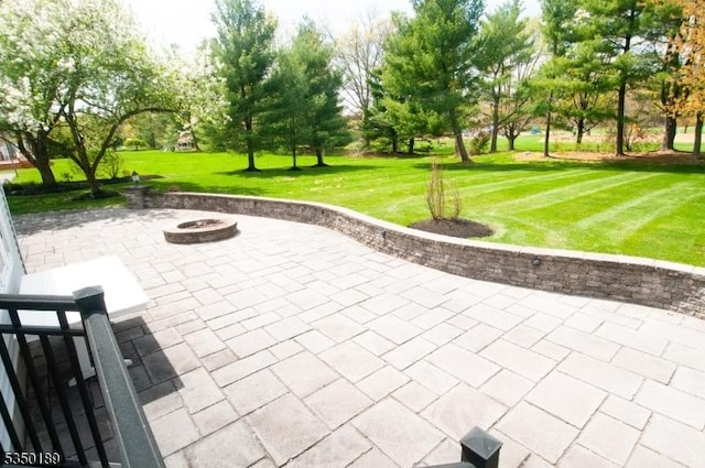 surrounding community with a patio, an outdoor fire pit, and a yard