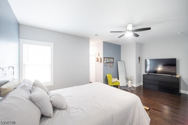 bedroom with dark wood-style flooring, baseboards, and ceiling fan