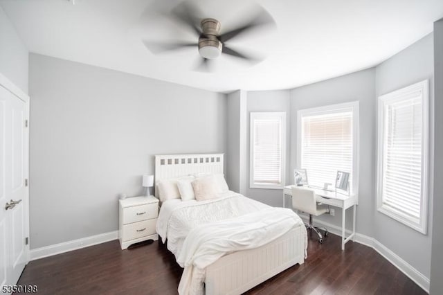 bedroom featuring ceiling fan, baseboards, and dark wood finished floors