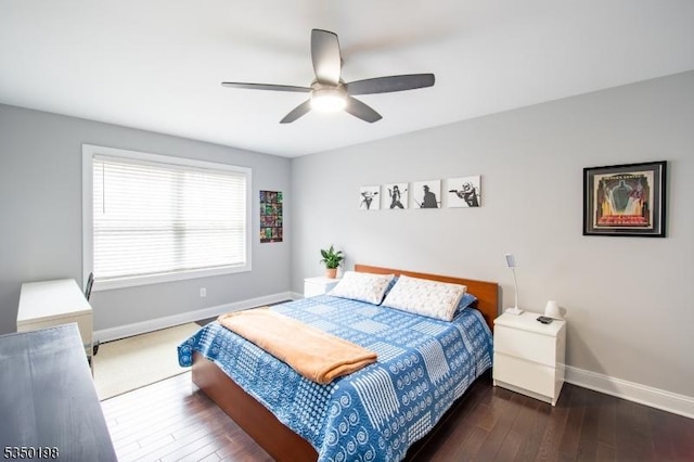 bedroom featuring baseboards, hardwood / wood-style floors, and a ceiling fan