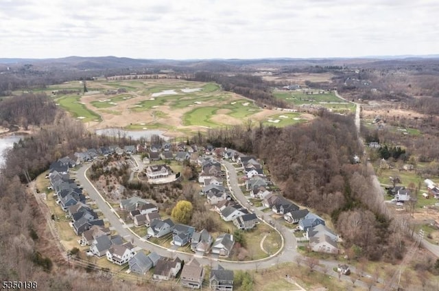 birds eye view of property with view of golf course, a residential view, and a water view