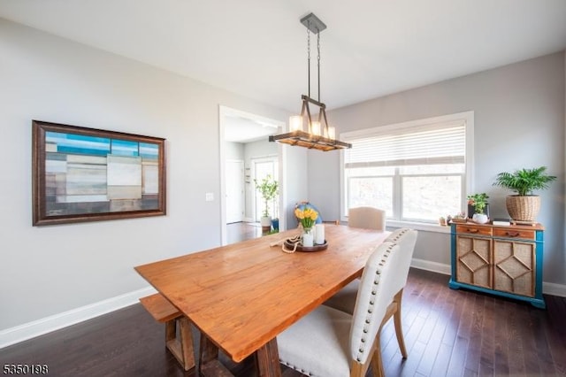 dining room featuring dark wood-type flooring, baseboards, and a healthy amount of sunlight