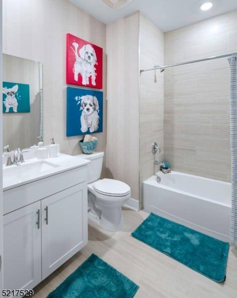 full bathroom with toilet, shower / tub combo, vanity, and tile patterned floors