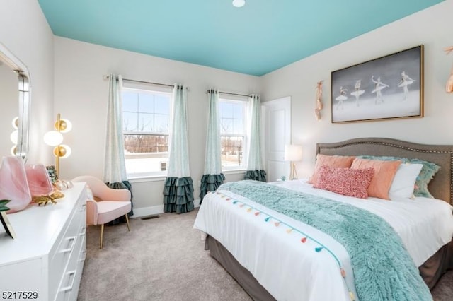 bedroom with light carpet, baseboards, and visible vents
