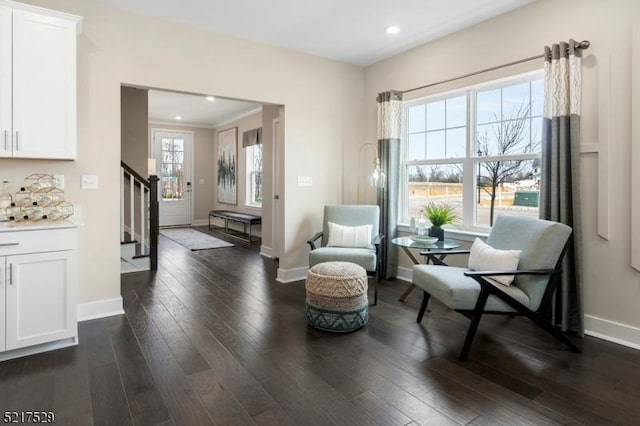 sitting room with dark wood-type flooring, recessed lighting, stairway, and baseboards
