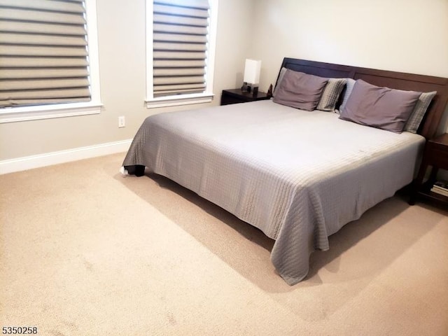 carpeted bedroom with baseboards