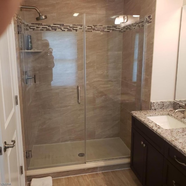 bathroom featuring vanity and a shower stall
