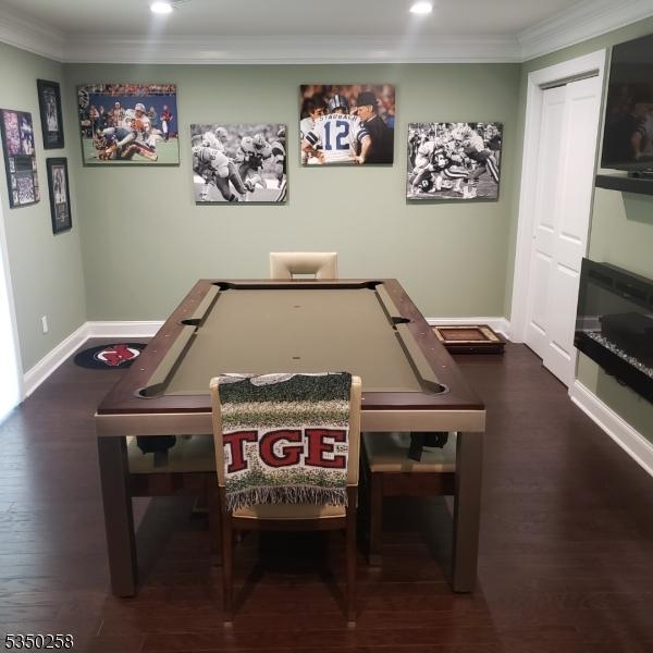 rec room featuring ornamental molding, baseboards, recessed lighting, and wood finished floors