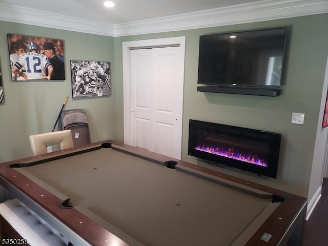 rec room featuring billiards, ornamental molding, and a glass covered fireplace