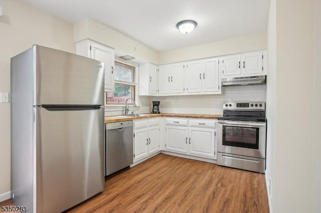 93 Stedwick Dr, Mount Olive Twp, NJ 07828 - kitchen with stainless steel appliances, under cabinet range hood, white cabinetry, light wood-style flooring, and light countertops