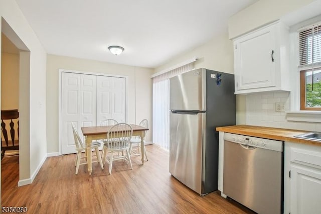 93 Stedwick Dr, Mount Olive Twp, NJ 07828 - kitchen with appliances with stainless steel finishes, white cabinets, light wood-style floors, and backsplash