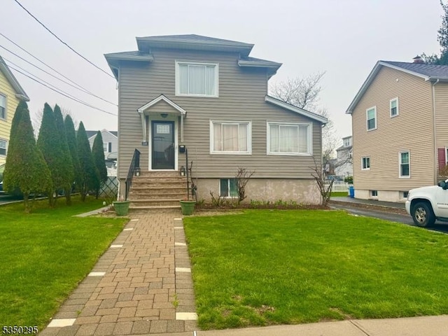 traditional-style house featuring a front yard and entry steps
