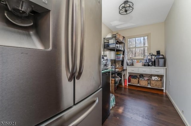 kitchen featuring freestanding refrigerator and dark wood finished floors