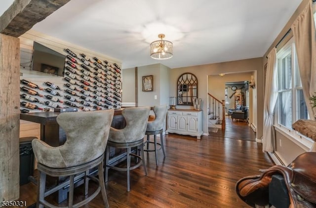 interior space featuring an inviting chandelier, stairs, and dark wood-style floors