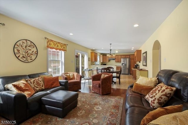 living room with recessed lighting, arched walkways, and wood finished floors