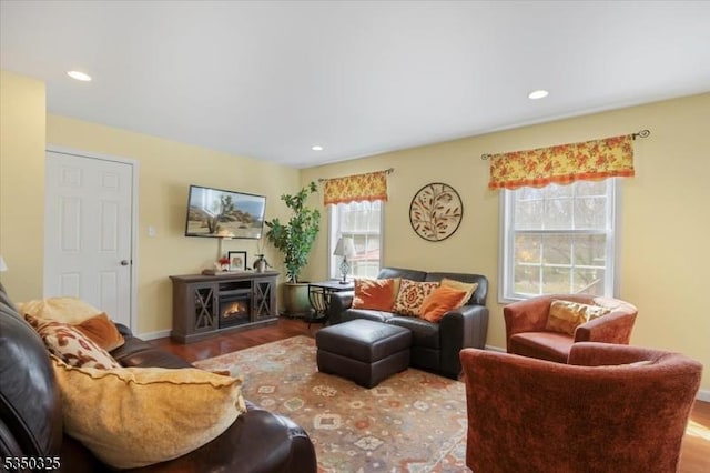 living area featuring wood finished floors, baseboards, and recessed lighting