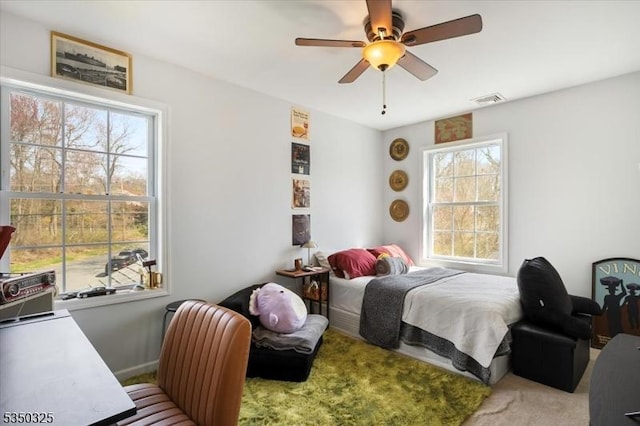 bedroom with a ceiling fan, visible vents, and carpet floors