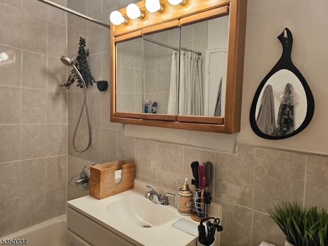 full bathroom featuring tile walls, shower / bath combination with curtain, backsplash, and vanity