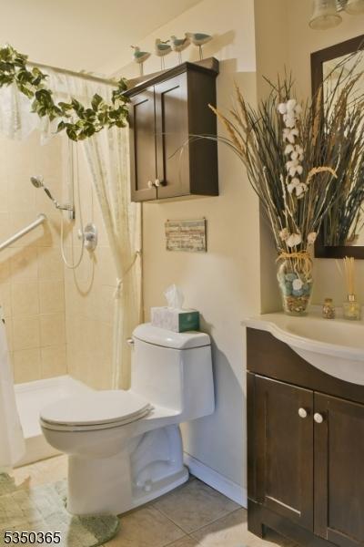 74 Longview Ave, Parsippany-Troy Hills Twp, NJ 07034 - bathroom with vanity, tile patterned flooring, a tile shower, and toilet