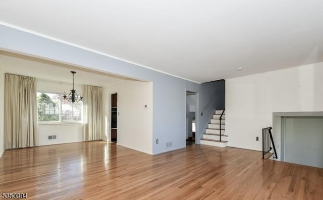 2462 Woodside Rd, Union Twp, NJ 07083 - unfurnished living room featuring a chandelier, light wood finished floors, and stairway