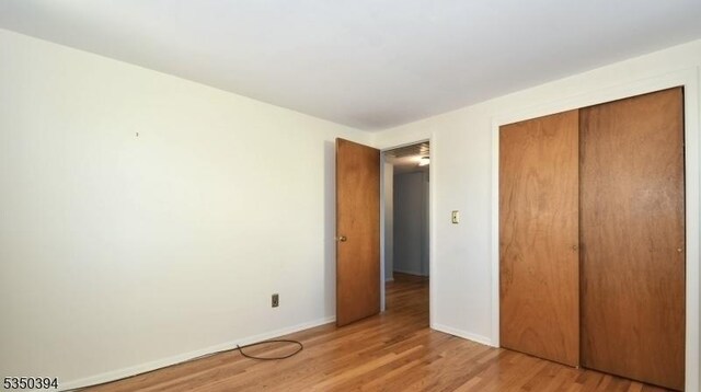 2462 Woodside Rd, Union Twp, NJ 07083 - unfurnished bedroom featuring light wood-style flooring, baseboards, and a closet
