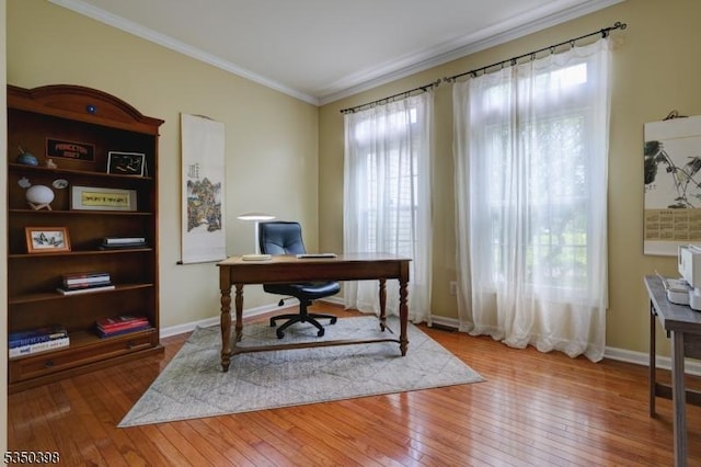 office with ornamental molding, hardwood / wood-style flooring, and baseboards