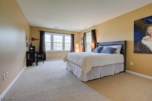bedroom featuring carpet and baseboards