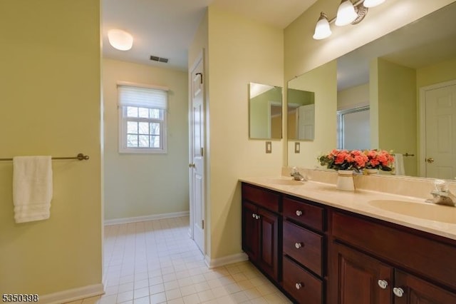 full bathroom with double vanity, baseboards, tile patterned flooring, and an enclosed shower