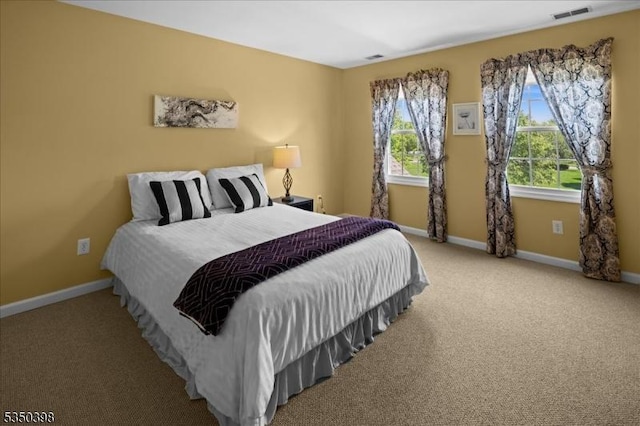 carpeted bedroom featuring baseboards