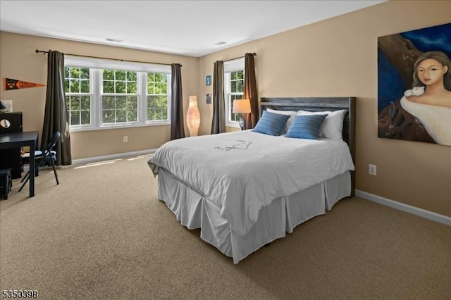 carpeted bedroom featuring baseboards
