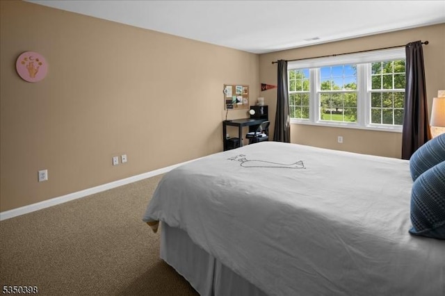 carpeted bedroom with baseboards