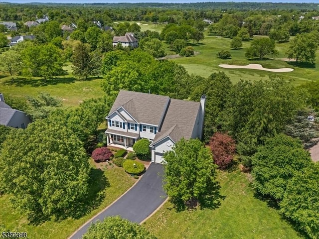 aerial view of property and surrounding area with a golf course