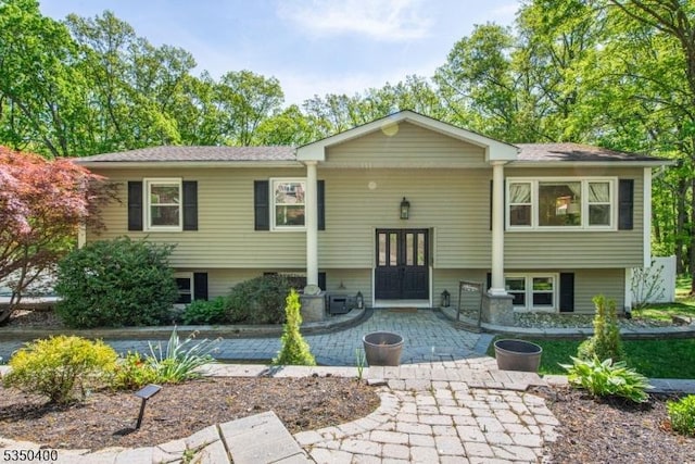 bi-level home featuring french doors and a patio area
