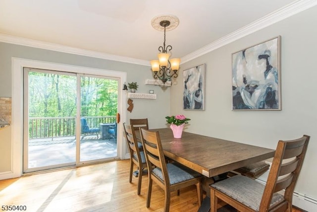 dining space with ornamental molding, light wood finished floors, a chandelier, and baseboard heating