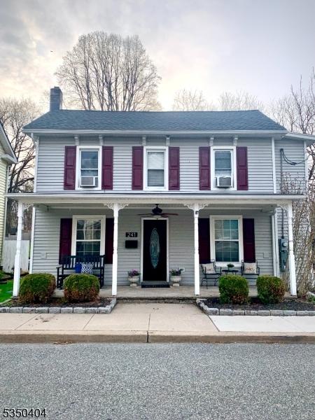 view of front of house with a porch and a chimney