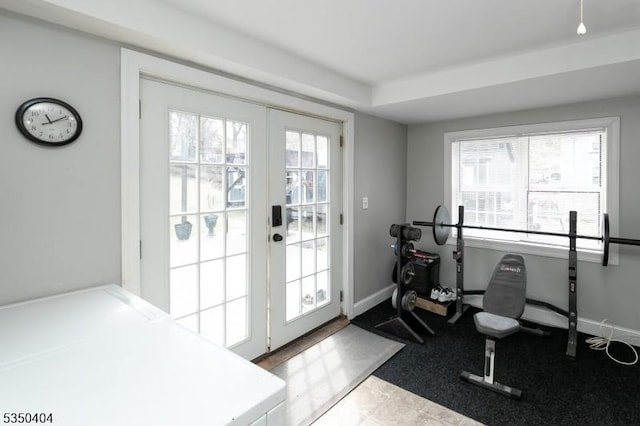 workout area with baseboards, french doors, and plenty of natural light