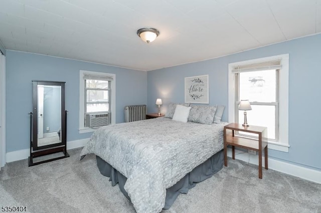 carpeted bedroom featuring baseboards and cooling unit