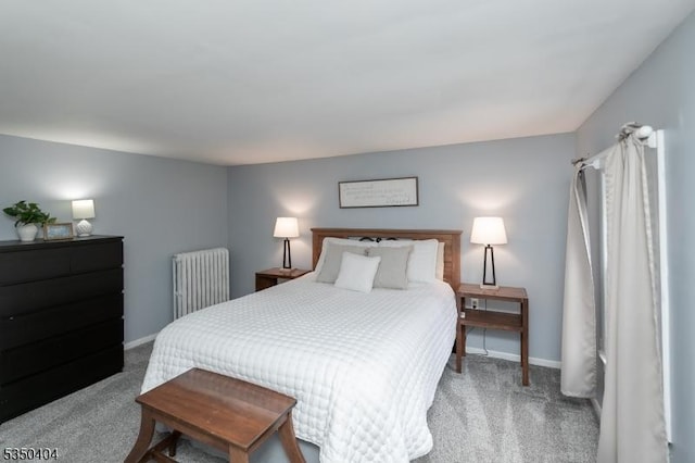 carpeted bedroom with radiator and baseboards