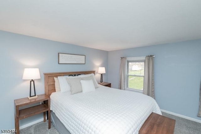bedroom featuring baseboards and carpet