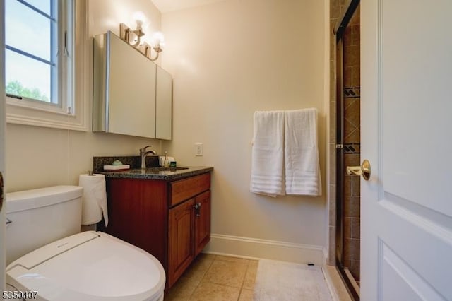 full bath featuring toilet, baseboards, tiled shower, tile patterned floors, and vanity