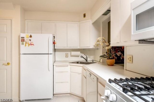 kitchen featuring light countertops, white appliances, white cabinetry, and a sink