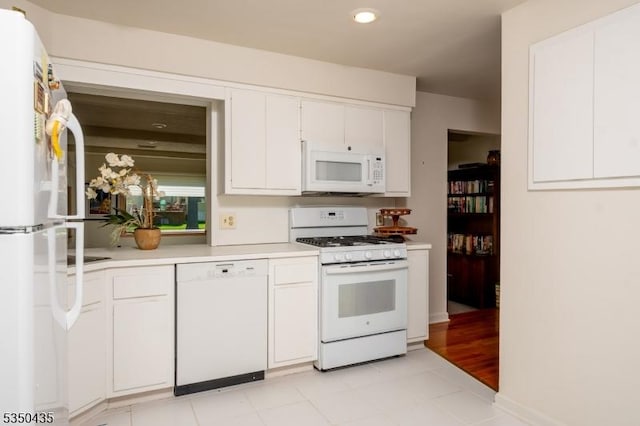 kitchen featuring white appliances, recessed lighting, white cabinets, and light countertops