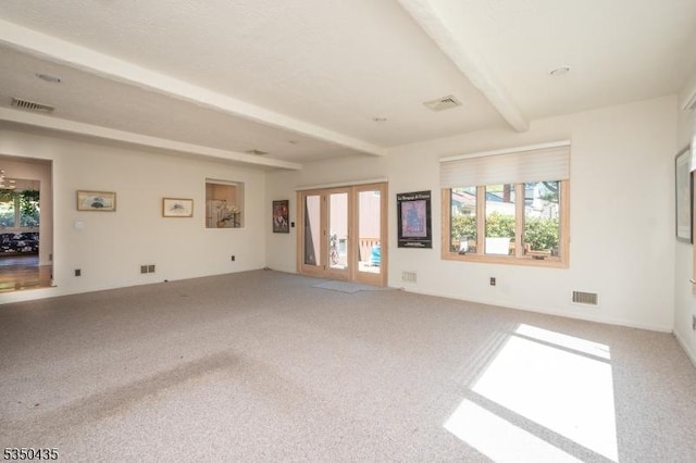 unfurnished living room with visible vents, carpet floors, and beamed ceiling