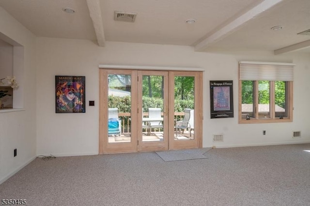 entryway featuring plenty of natural light, beamed ceiling, and visible vents