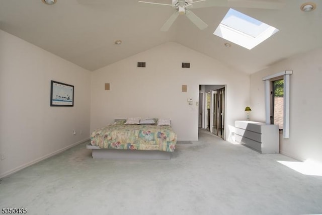 bedroom with visible vents, carpet, ceiling fan, and vaulted ceiling with skylight