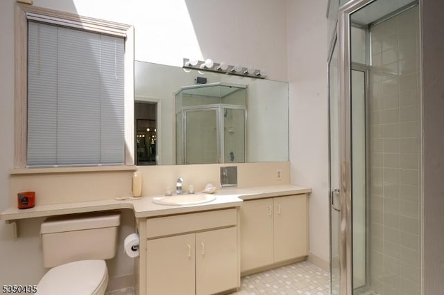 bathroom featuring vanity, toilet, and a stall shower